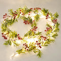 Lighted Christmas garland with green leaves and red berries, featuring 20 warm white LED lights.