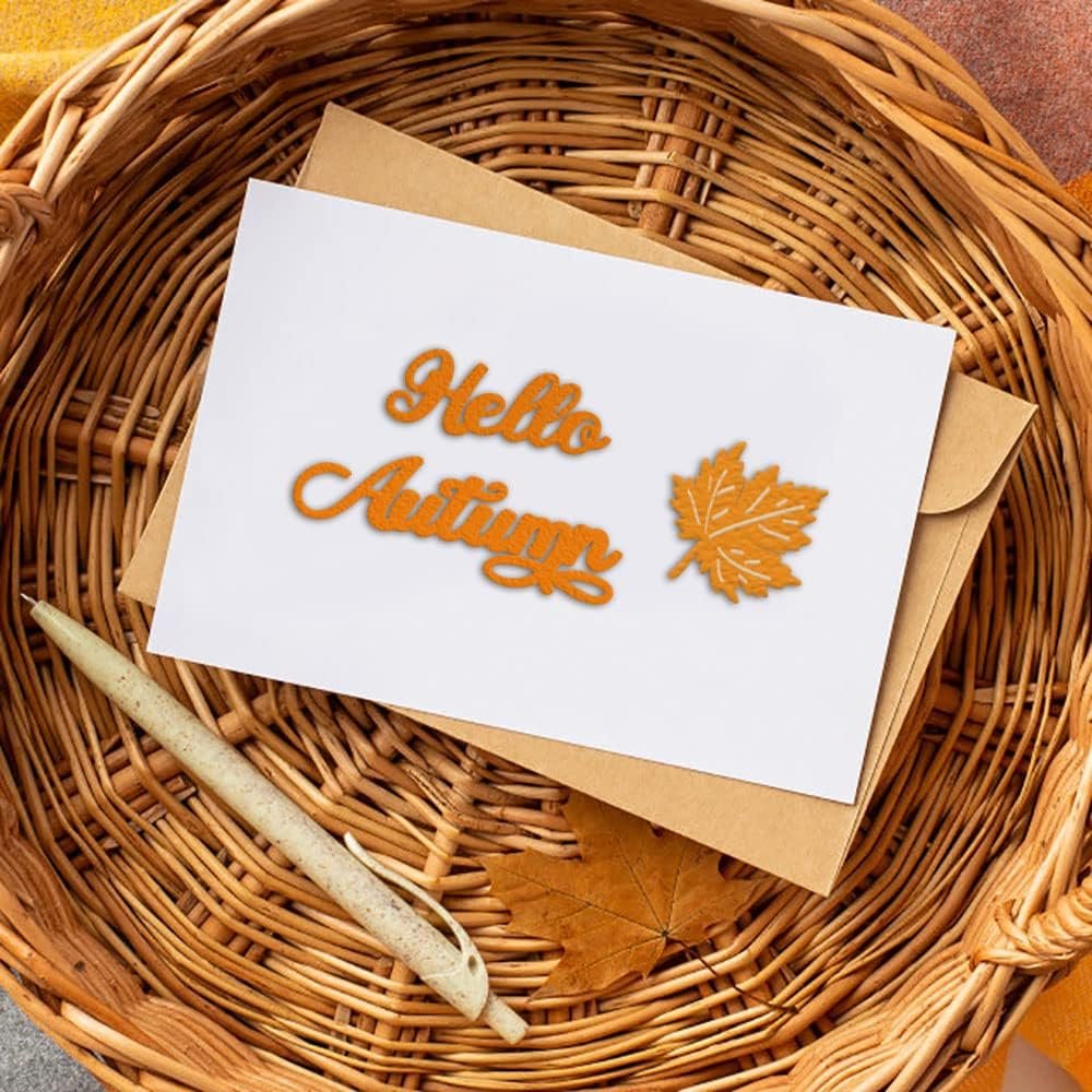Autumn cutting die set with 'Hello Autumn' text and maple leaf shape on a card, next to a pen in a basket.
