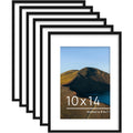 Six black wood picture frames arranged in a staggered pattern, one frame displays a landscape photo with text.