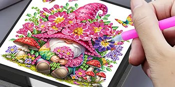 Diamond art gnome with flowers and mushrooms, being created with a pink tool.