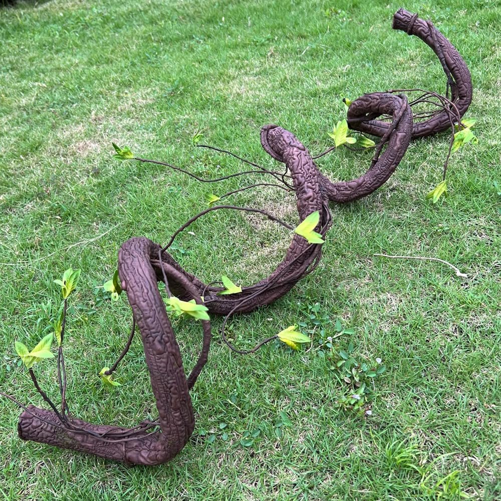 Bendable artificial tree trunk vine with faux moss and leaves on green grass