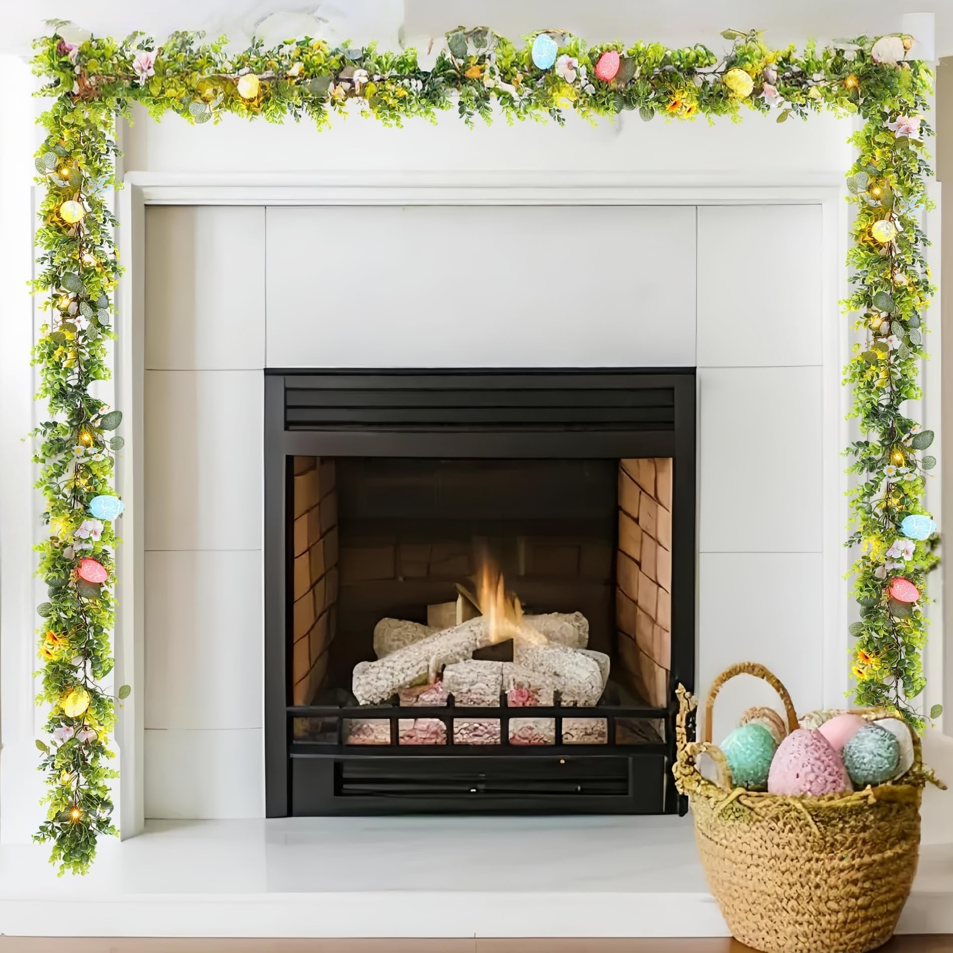 Easter garland with eucalyptus leaves, daisies, pink blossoms, decorative eggs, and warm white LED lights draped over a fireplace mantel.