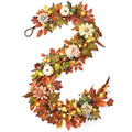 Autumn garland with artificial leaves, flowers, and mini pumpkins, illuminated by warm LED lights, on a white background.