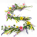 Farmhouse spring flower garland with pink, white, yellow wildflowers and daisy accents on a white background.