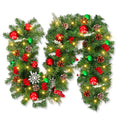 Christmas garland with warm white LED lights, pinecones, red and green ornaments, and snowflakes on a white background.