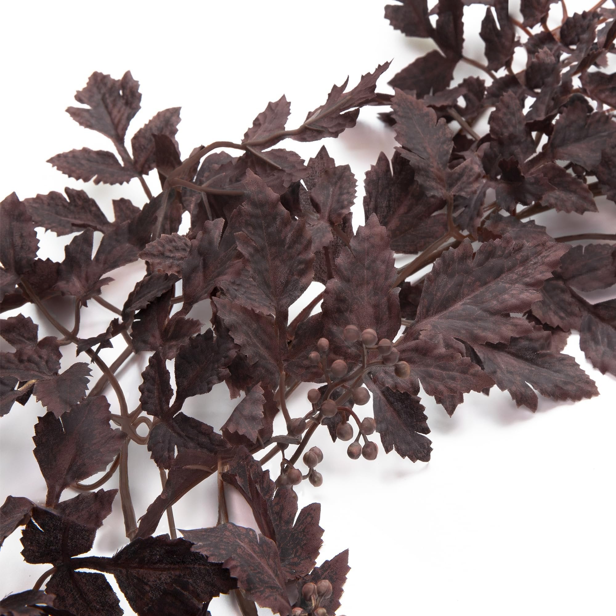 Dark brown artificial garland with serrated leaves and small berry clusters on a white background