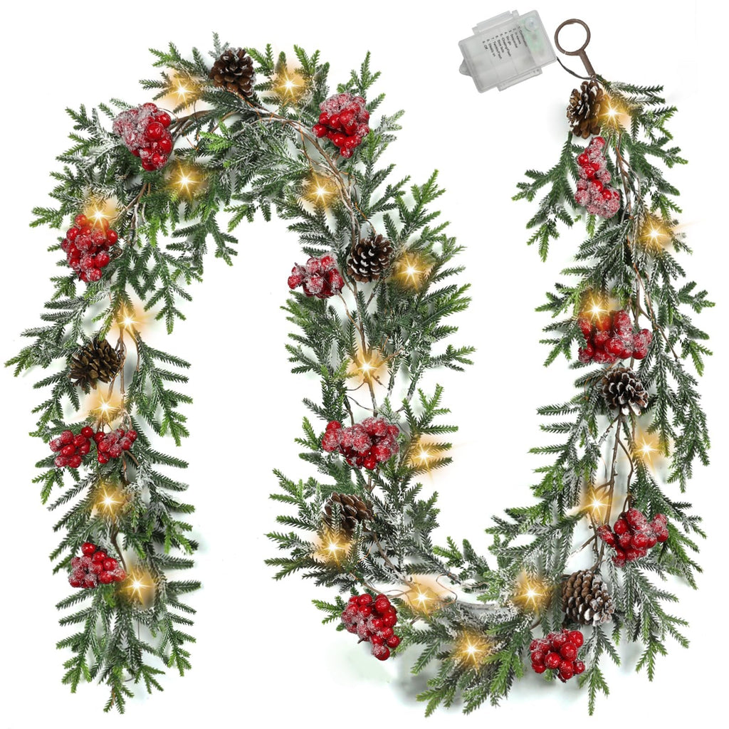 Pre-lit artificial pine Christmas garland with red berries, pine cones, and LED lights on a white background.