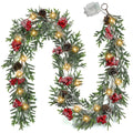 Pre-lit artificial pine Christmas garland with red berries, pine cones, and LED lights on a white background.
