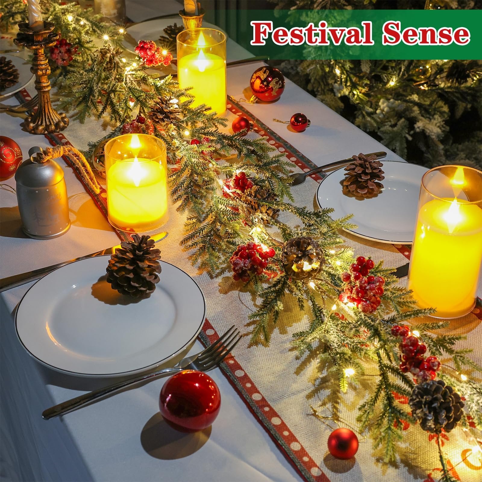 Flocked artificial pine Christmas garland with LED lights and red berries on a table setting.