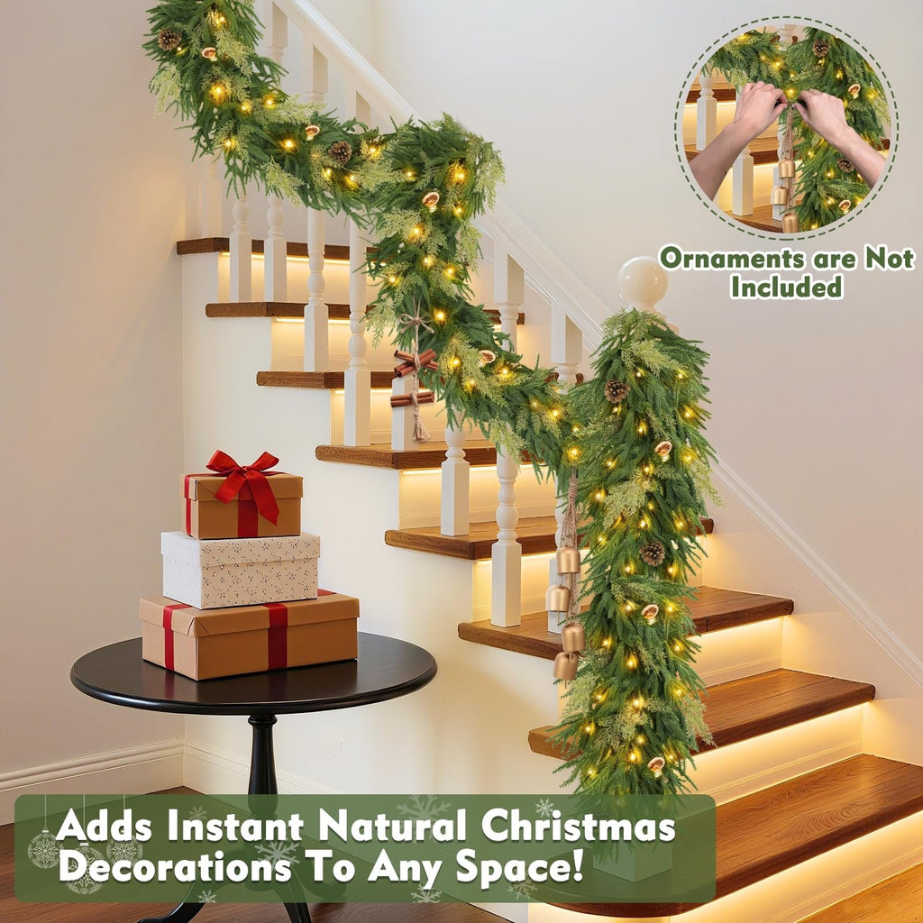 Prelit Christmas garland with lights and pinecones draped on a staircase with gift boxes on a table