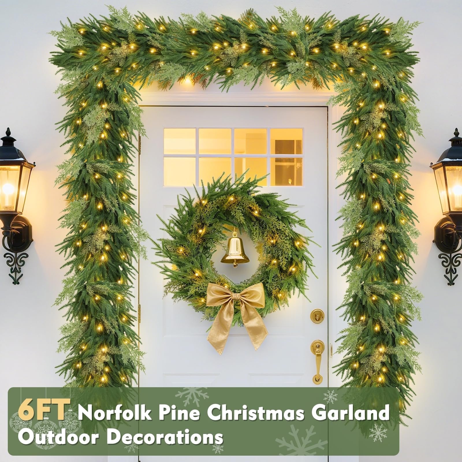 Prelit Christmas garland and wreath decorating a white door with lanterns on either side.