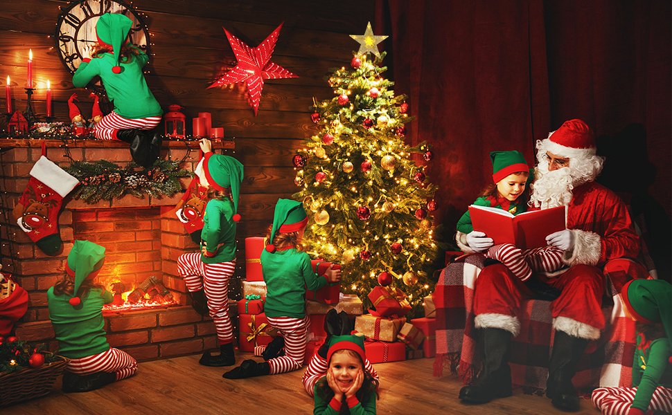 Christmas tree topper star glowing warm white on top of a decorated Christmas tree with children and Santa Claus in a cozy room