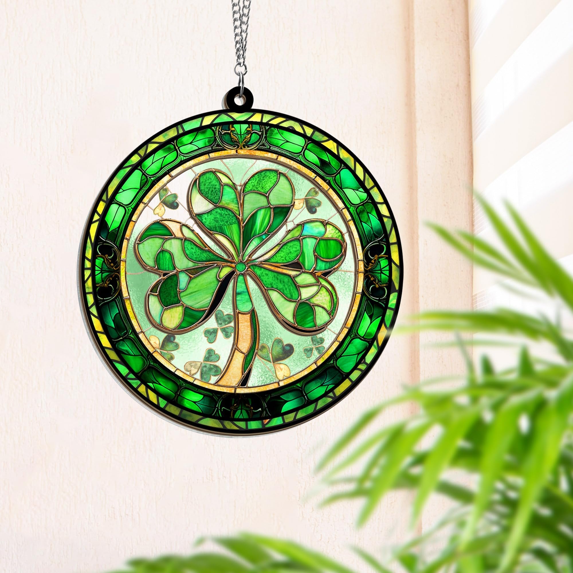 Round stained glass shamrock suncatcher hanging on a chain, with green and yellow glass details.