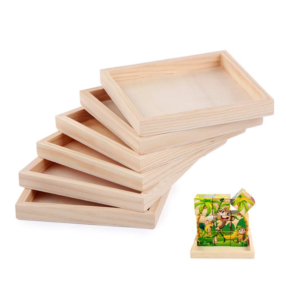 Stack of five unfinished wooden serving trays with a small wooden tray holding a monkey-themed block puzzle on the side