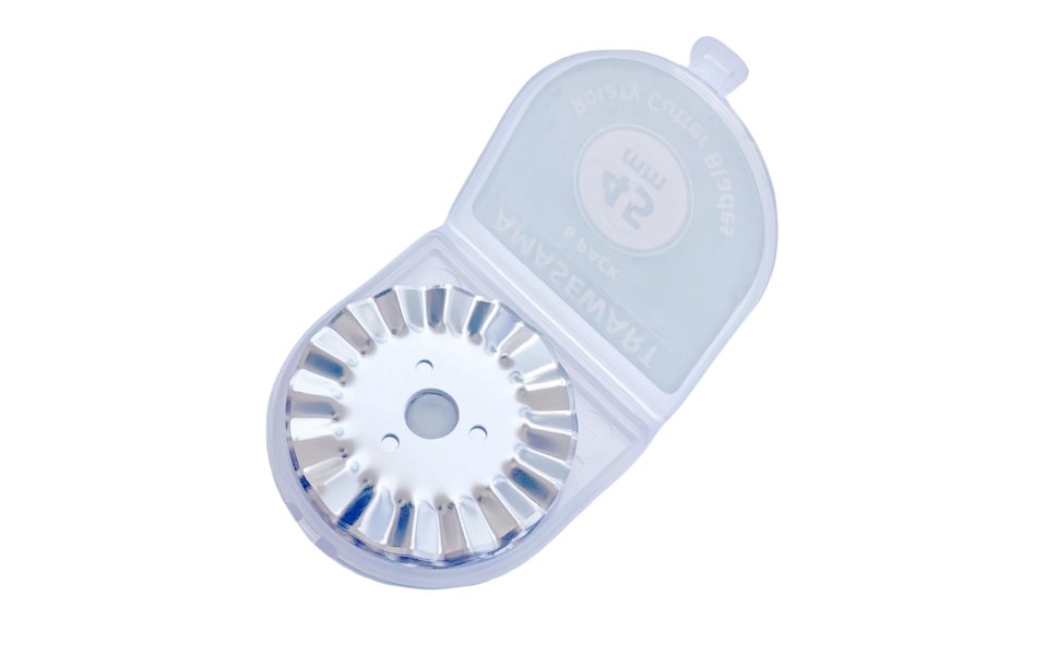 Rotary cutter blade with pinking edge inside a clear plastic storage case