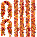 Six strands of artificial fall maple leaf garland in red, orange, and yellow hues, displayed against a white background.