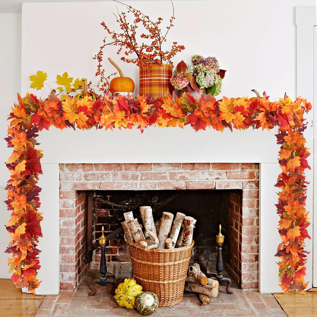 Artificial fall maple leaf garland draped over a fireplace mantel with autumn decor