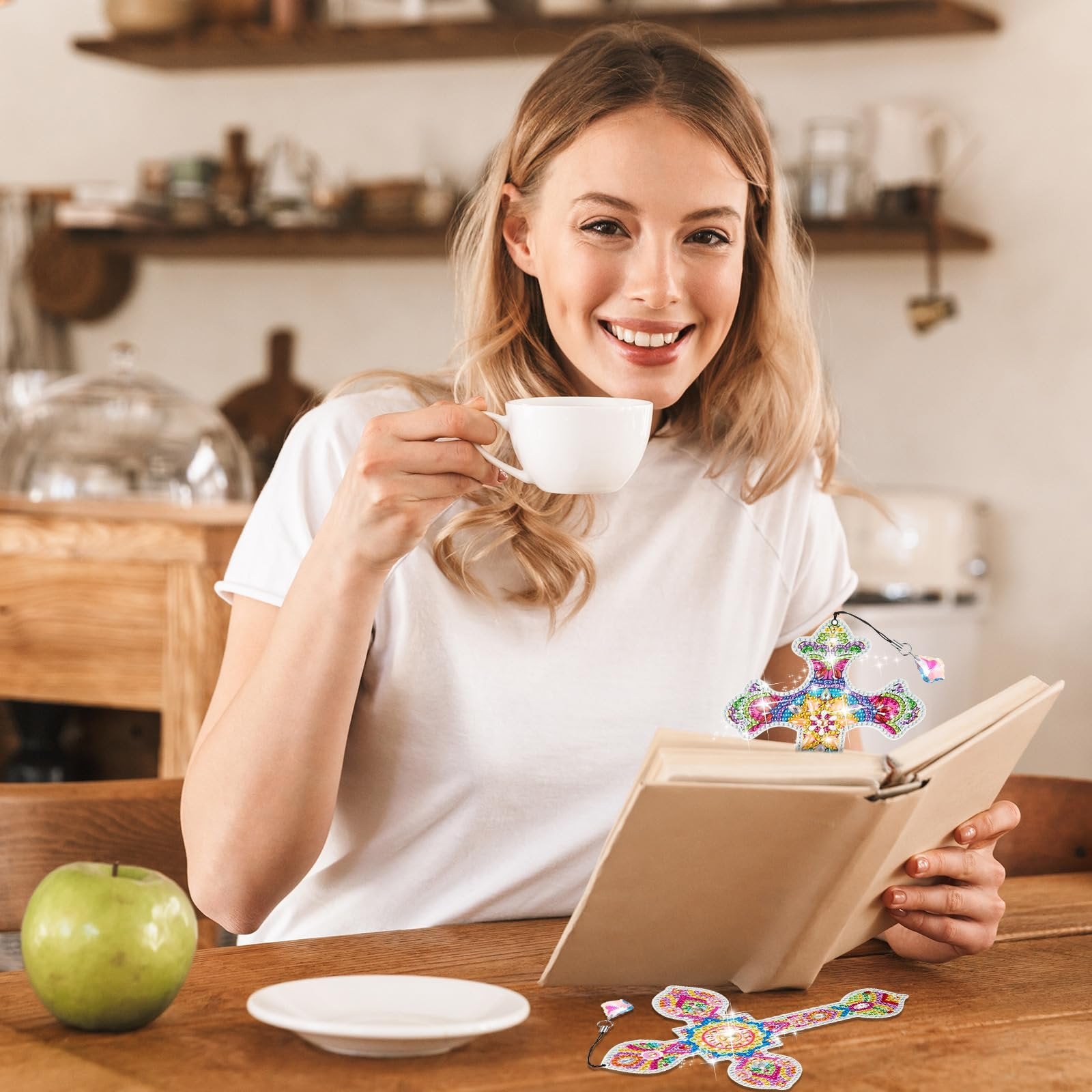 Woman drinking coffee and holding a book with a diamond art cross bookmark
