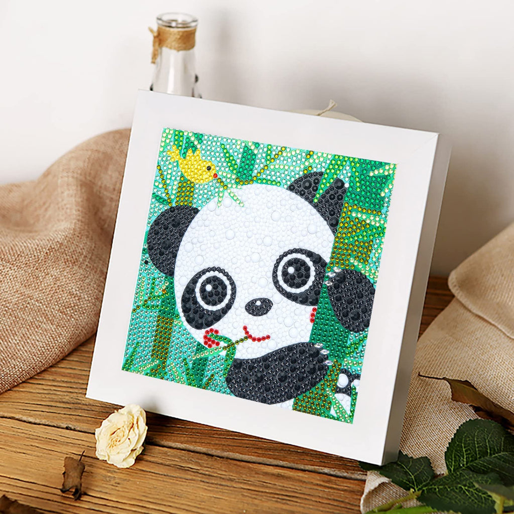 Diamond painting kit featuring a cute panda with a yellow bird and bamboo, framed in white.