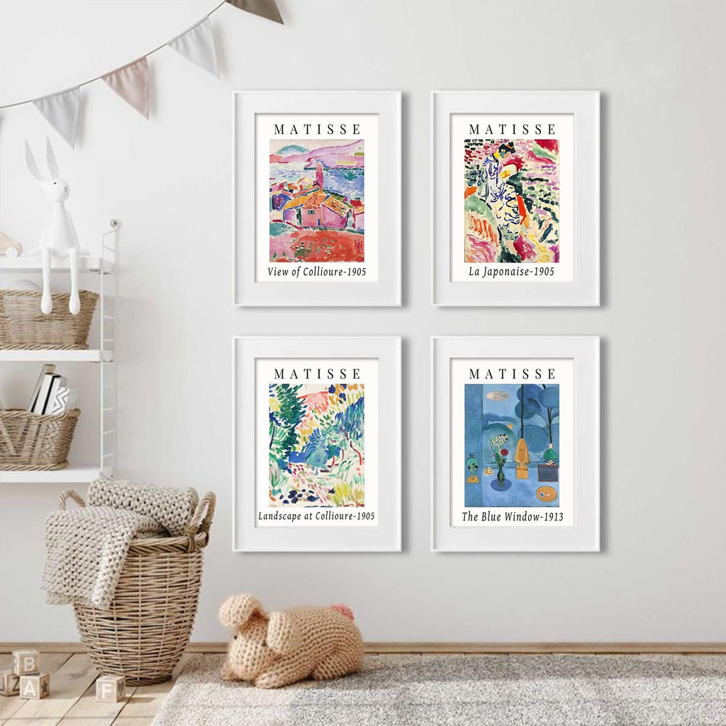Four framed Matisse art prints displayed on a wall above a basket and stuffed toy.