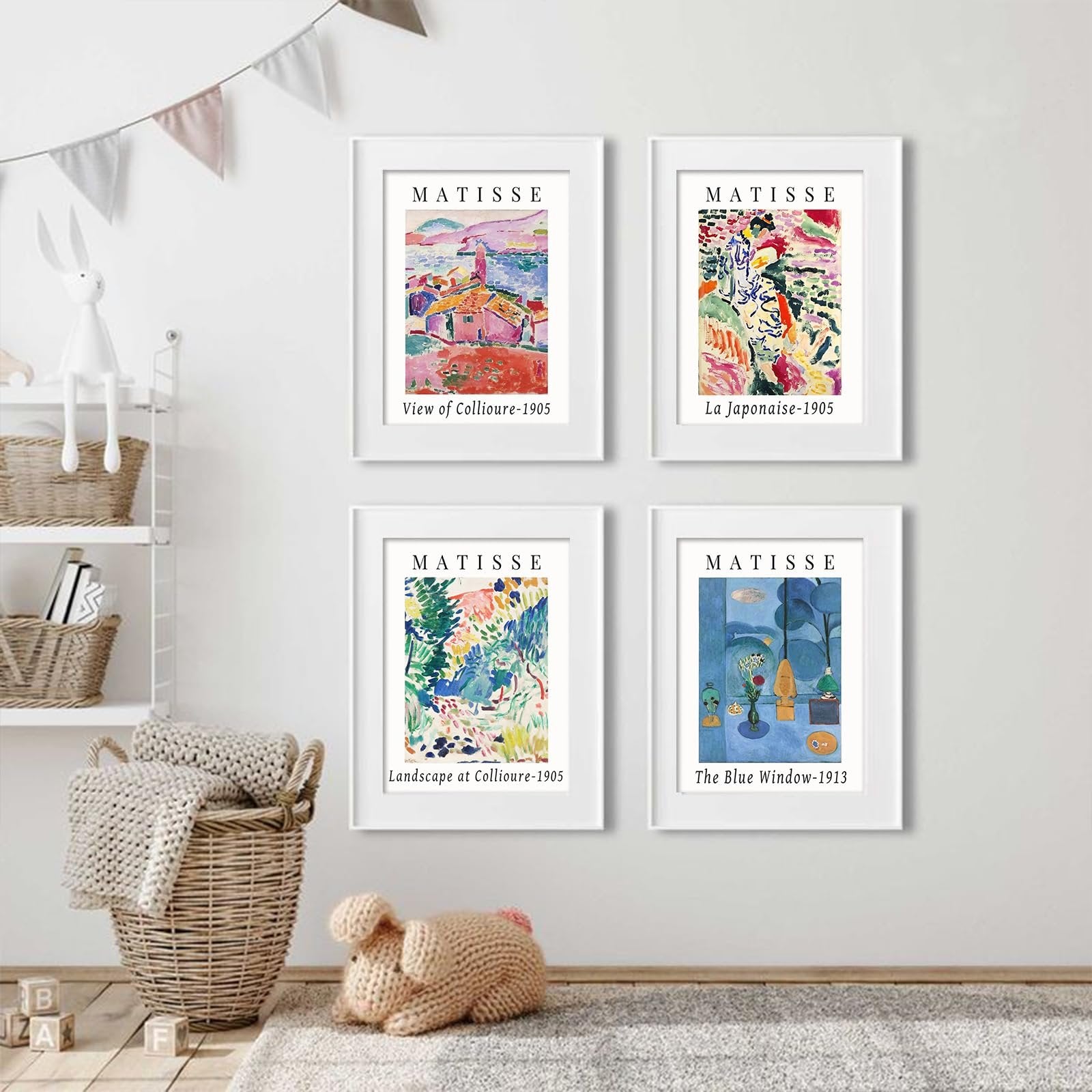 Four framed Matisse art prints displayed on a wall above a basket and stuffed toy.