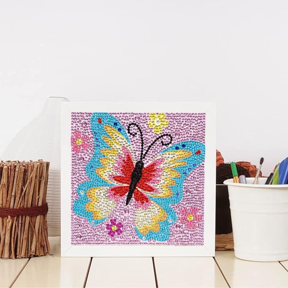 Diamond painting kit featuring a colorful butterfly with pink flowers, framed and displayed on a white surface.