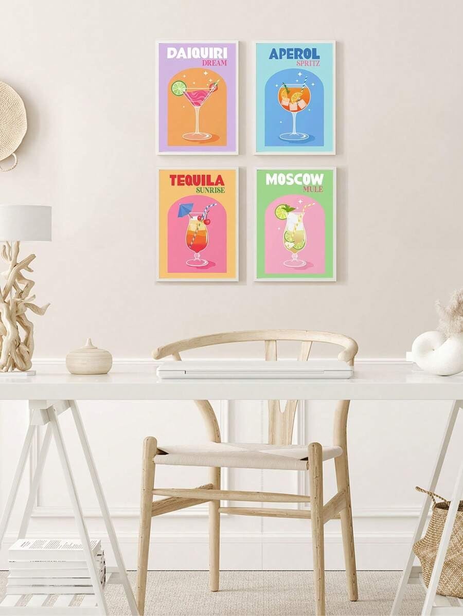 Four framed retro cocktail art prints hanging on a wall above a desk and chair.