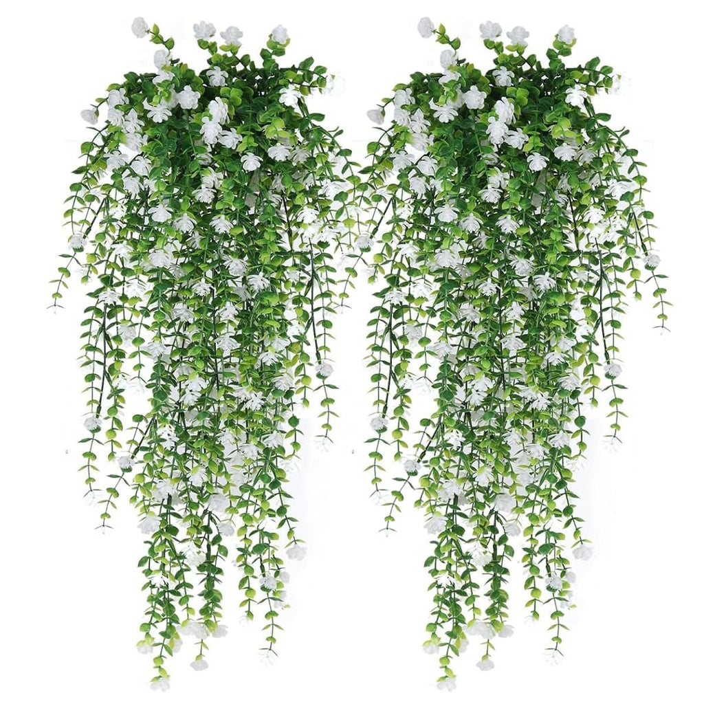 Two artificial hanging flower garlands with white blossoms and green eucalyptus vines against a white background.