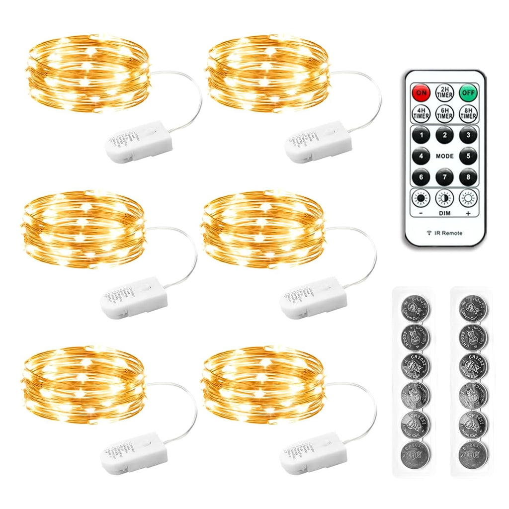 Six battery-operated fairy light strings with remote and batteries on a white background.