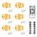 Six battery-operated fairy light strings with remote and batteries on a white background.