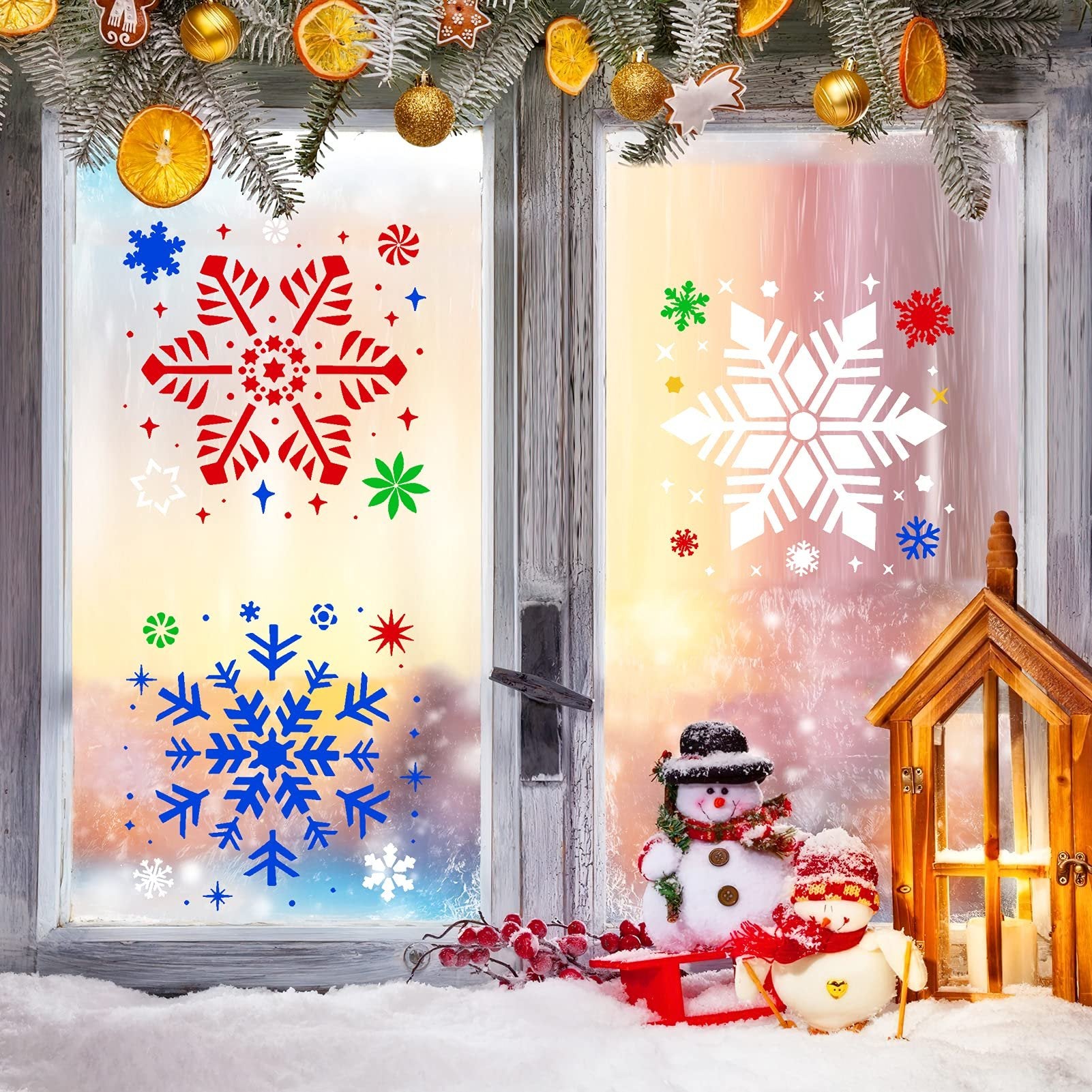 Christmas window decorated with snowflake stencils, snowmen, and festive ornaments