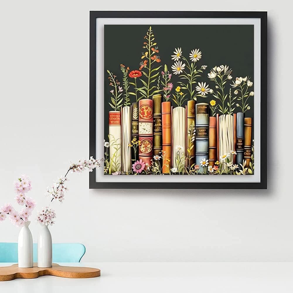 Framed diamond painting kit artwork depicting a row of vintage books with wildflowers growing in front and behind them.