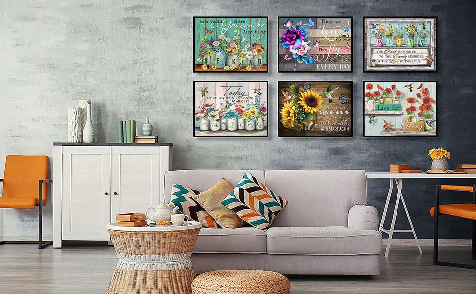 Living room scene with eight framed diamond painting kits displayed on a wall above a sofa and cabinet.