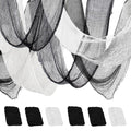 Black and white creepy cloth gauze draped and folded, with swatches of black and white fabric below on a white background.