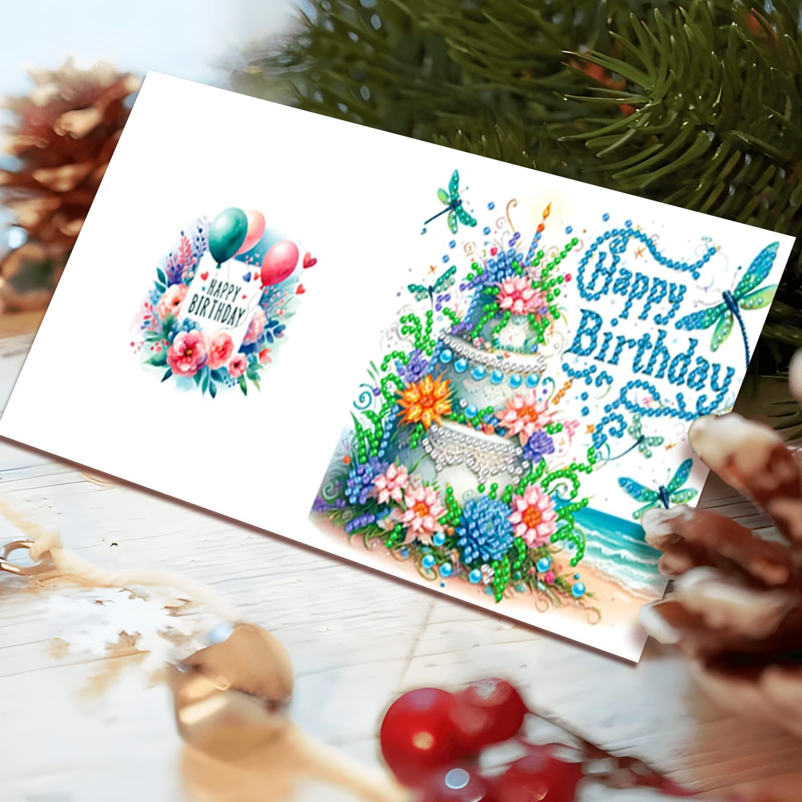 Diamond painting happy birthday card featuring a cake and balloons, with dragonflies and beach scene.