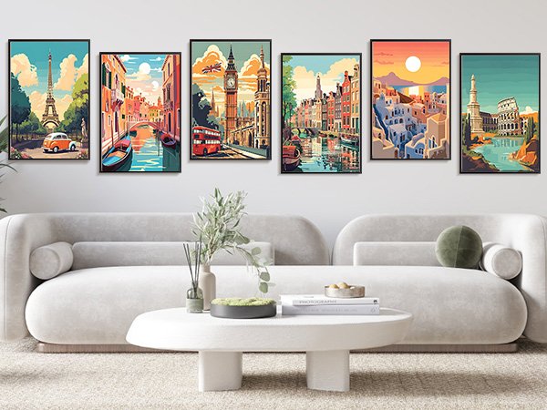 Six framed travel destination art prints displayed above a sofa, including Paris, Venice, London, Amsterdam, Santorini, and Rome.