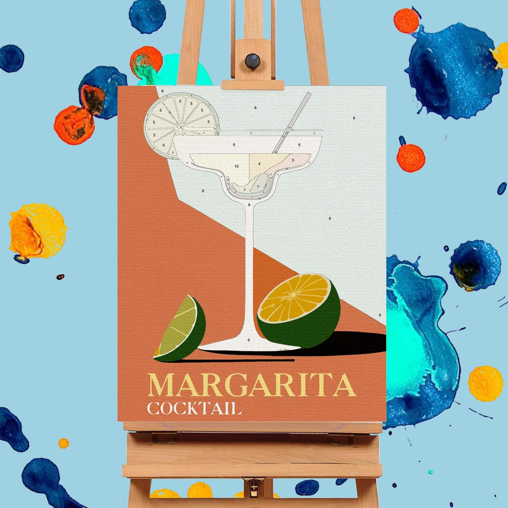 Paint by numbers canvas showing a margarita cocktail with limes on an easel, surrounded by colorful paint splatters.