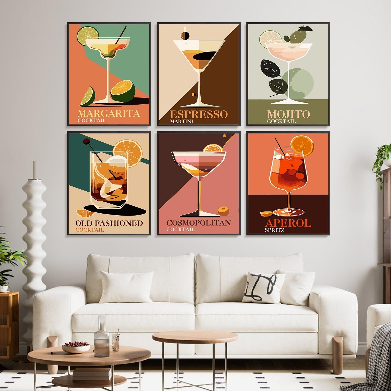Six framed cocktail art prints displayed on a wall above a sofa, featuring Margarita, Espresso Martini, Mojito, Old Fashioned, Cosmopolitan, and Aperol Spritz.