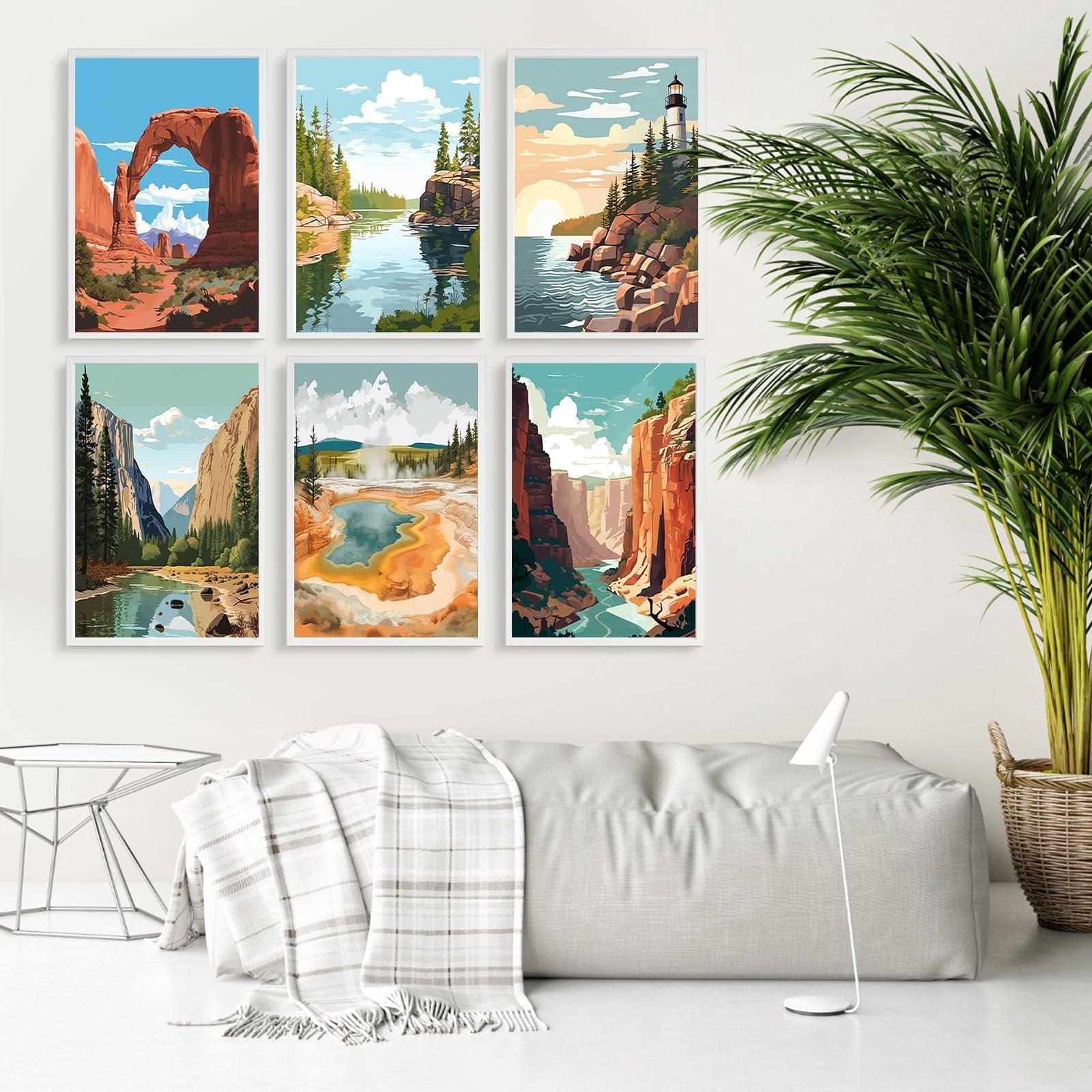 Six framed landscape paintings of national parks displayed on a white wall above a sofa.