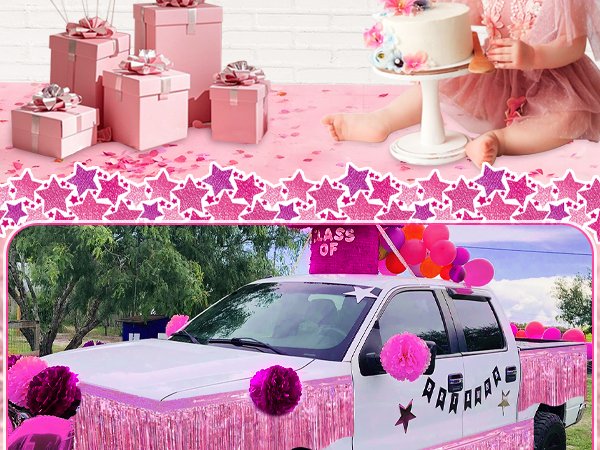 Pink foil fringe garland decorating a truck and party gifts with a cake and child in the background.