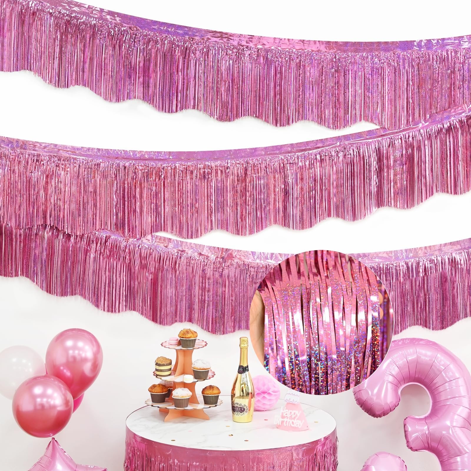Pink foil fringe garlands draped across a white background, with a party table setup below featuring balloons, cupcakes, and a champagne bottle.