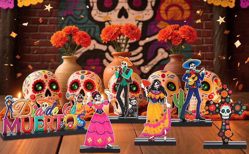 Day of the Dead centerpiece set with sugar skulls, figures, and floral cross on a wooden table.
