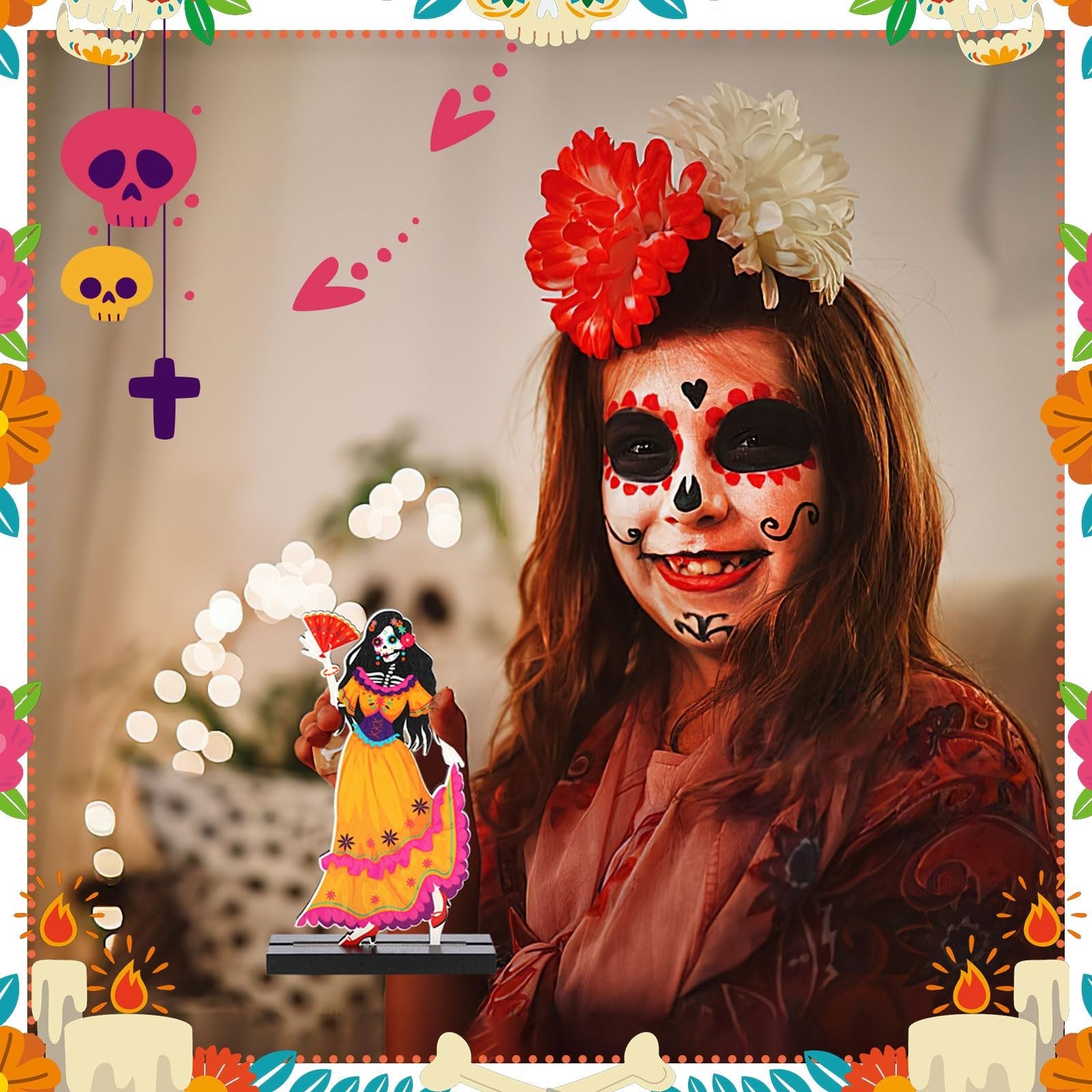 Girl with Day of the Dead face paint holding a sugar skull centerpiece figure, surrounded by festive decorations.
