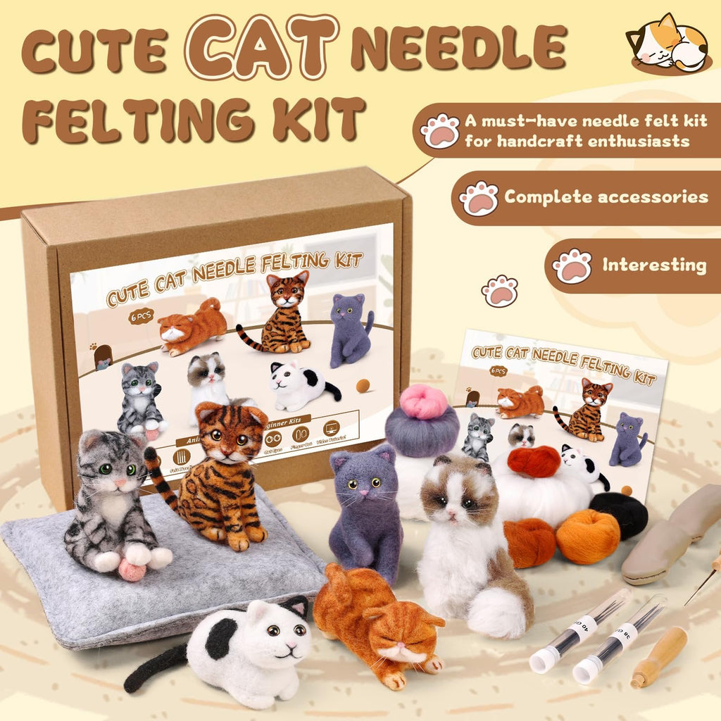 Various felted cat figures and materials from a needle felting kit, arranged around a product box.