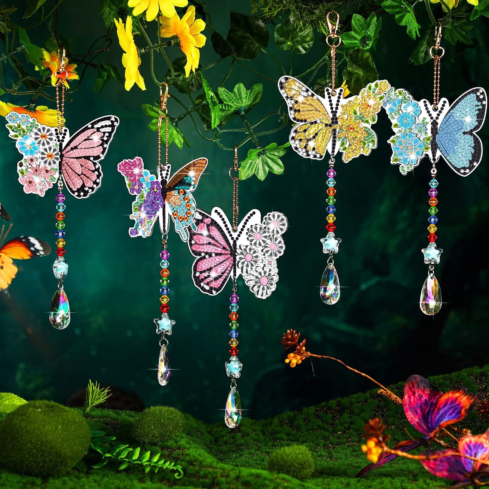 Six double-sided diamond painting butterfly suncatchers hanging from branches with crystals and beads
