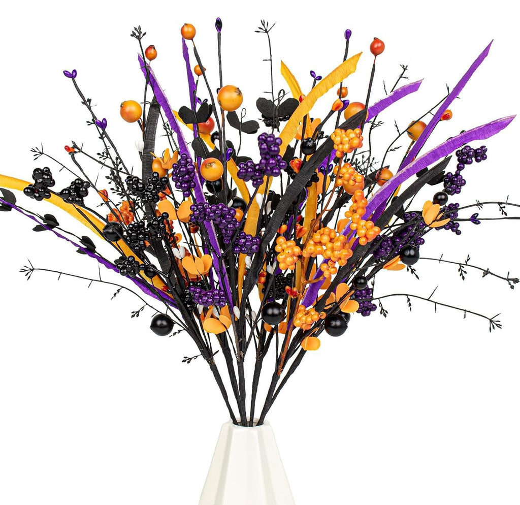 Halloween artificial floral arrangement with black stems, purple and orange berries, and black balls in a white vase.