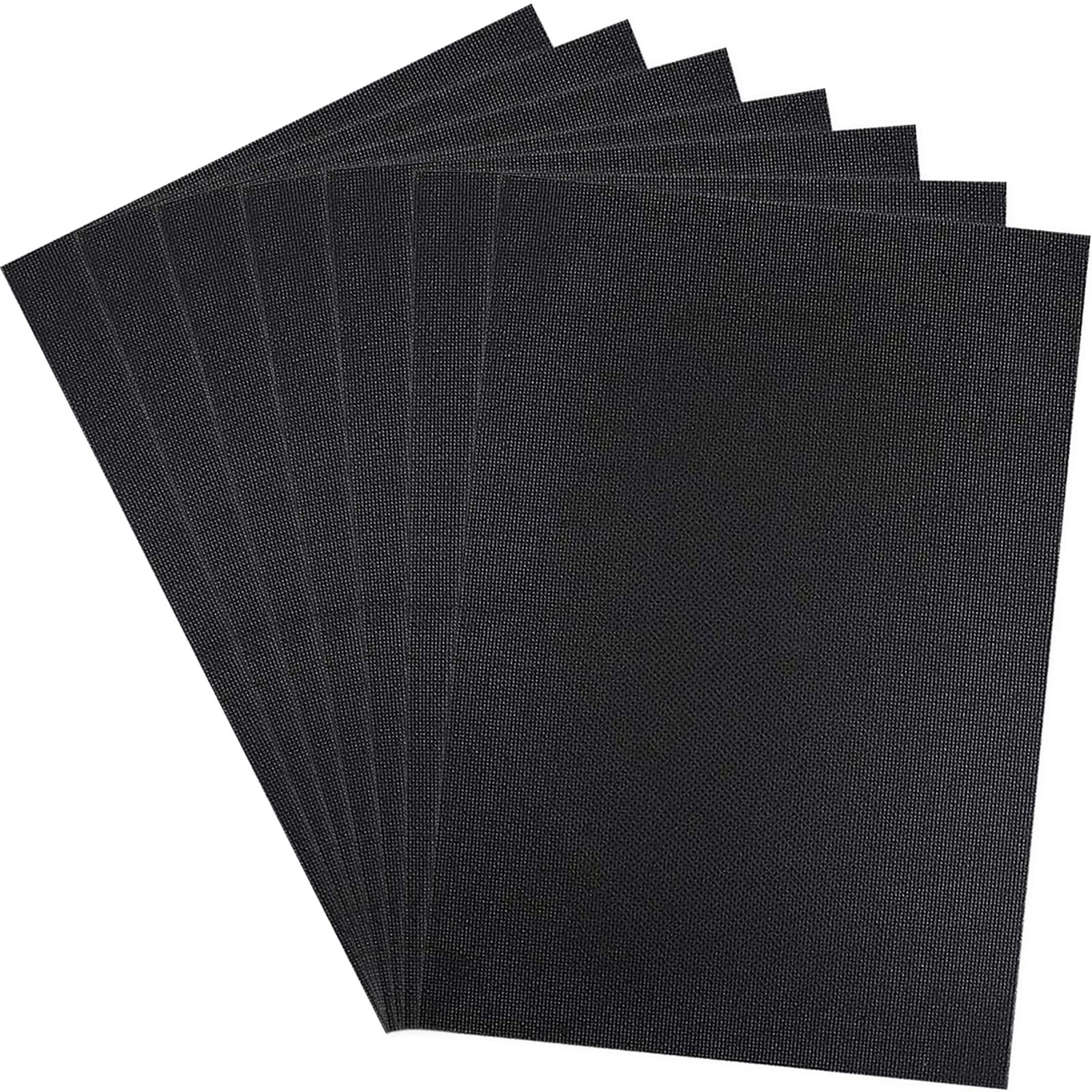 Six pieces of black Aida cloth fanned out against a white background, showing the woven texture.