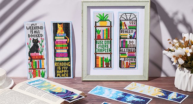 Cross stitch bookmarks with book and cat designs, some with text like 'My Weekend is All Booked' and 'Reading is My Happy Place'.