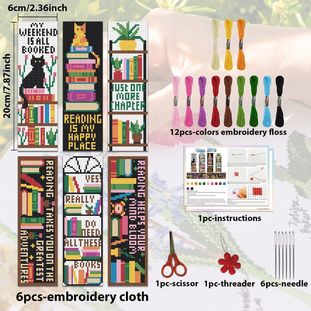 Cross stitch bookmark kit contents including stamped cloth, embroidery floss, needles, scissors, threader, and instructions.