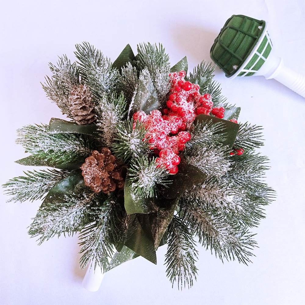 Christmas floral bouquet holder with pine branches, pinecones, and red berries, on a white background.